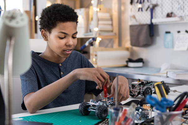 middle-school student working on robotics project