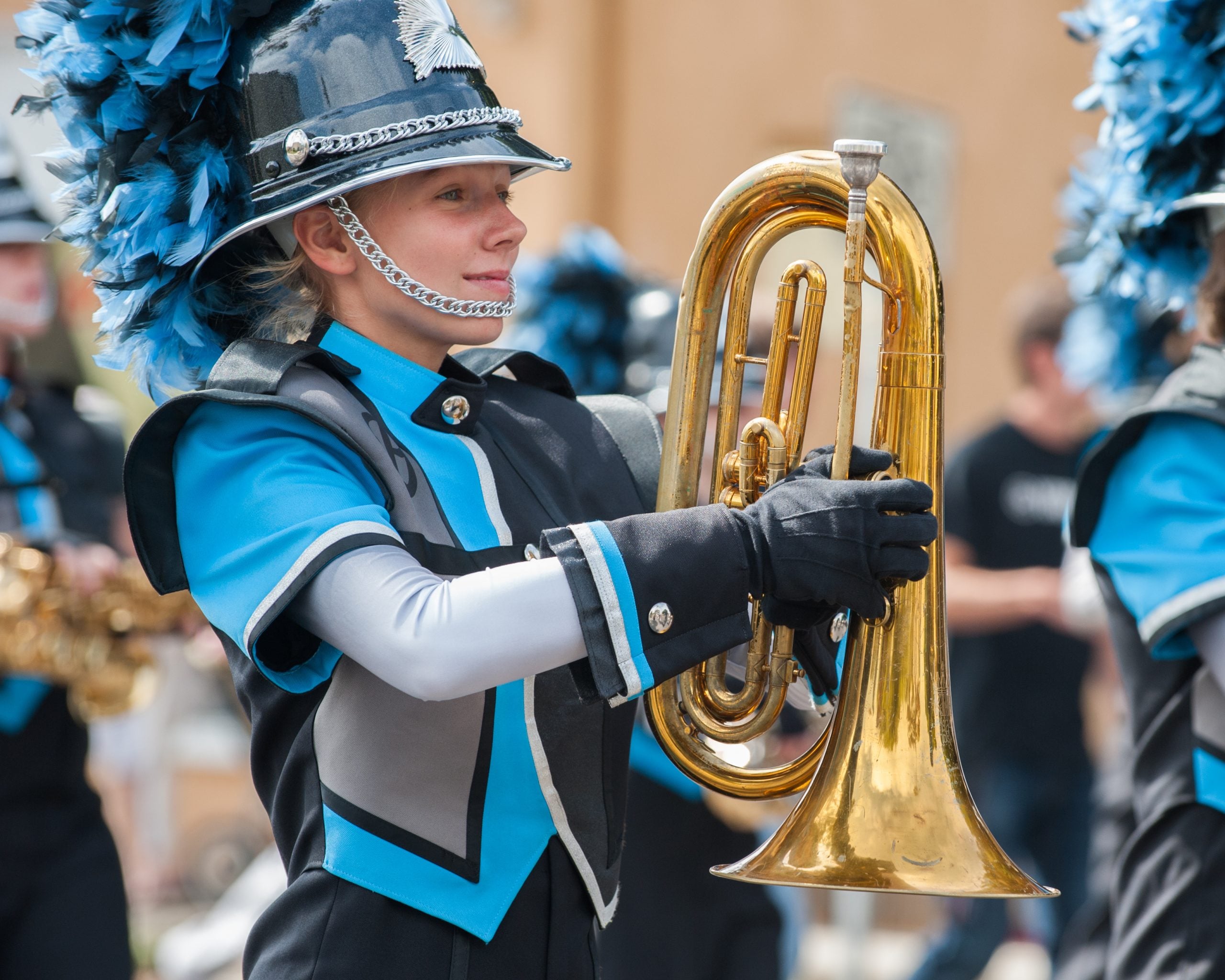 Teen baritone player marching in the band.